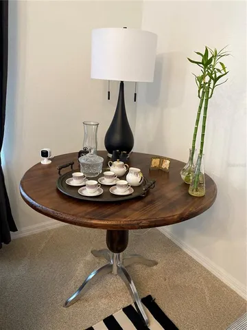 a table with a vase and flowers on it