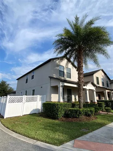 a living room with a couch and a potted plant