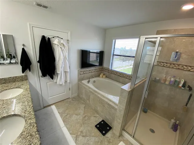 a living room with furniture and a baby crib