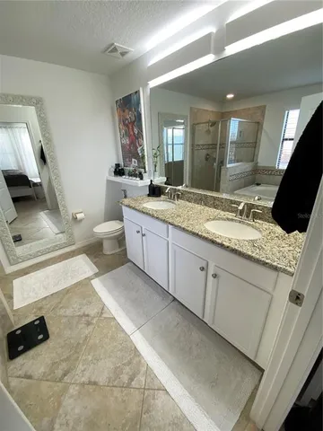 a white toilet sitting next to a bathroom sink