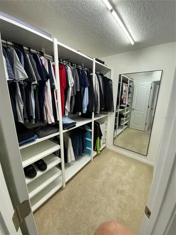a bathroom with a granite countertop sink a mirror and a shower