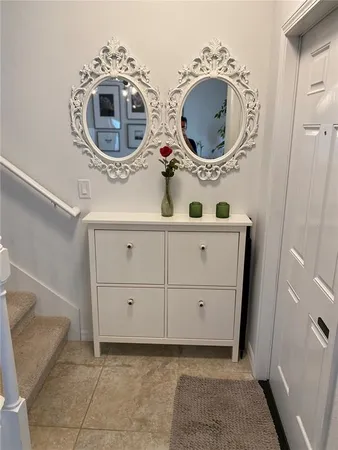 a bathroom with a granite countertop sink a mirror and a shower