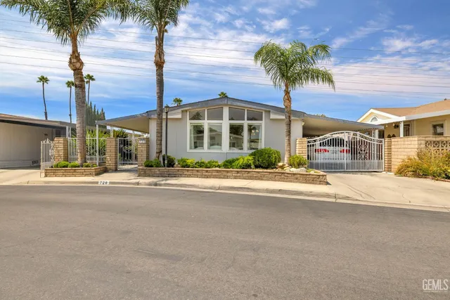 a front view of a building with palm trees