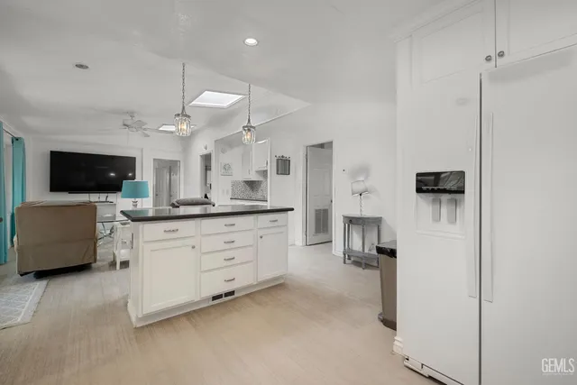 a large room with a lot of furniture and flat screen tv