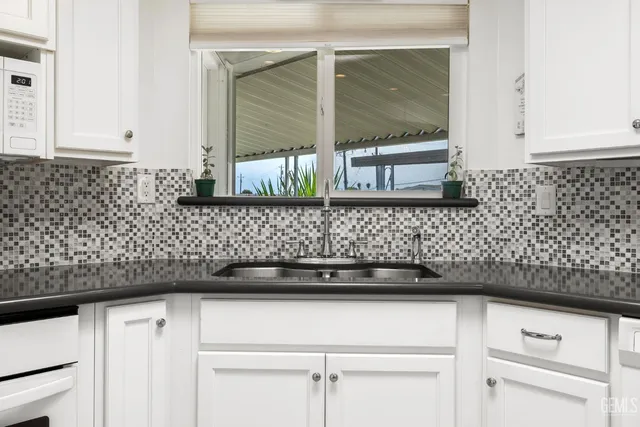 a kitchen with a sink and cabinets