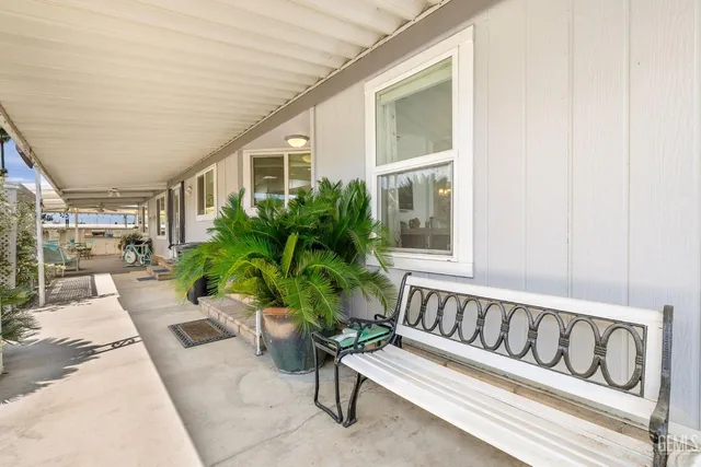 a view of a porch with furniture and a potted plant