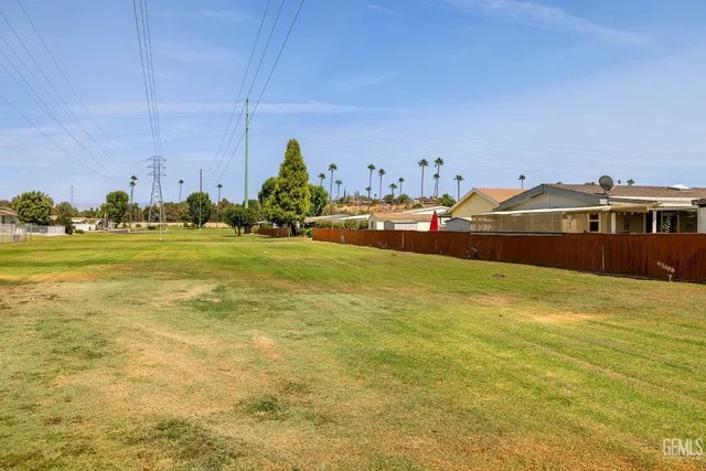 a swimming pool with outdoor seating and yard