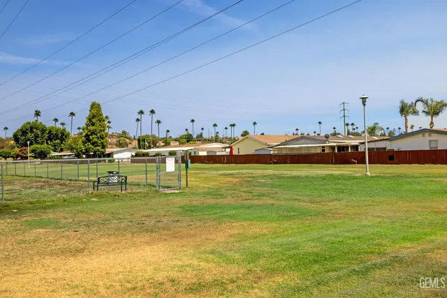 a front view of a house with a yard and potted plants