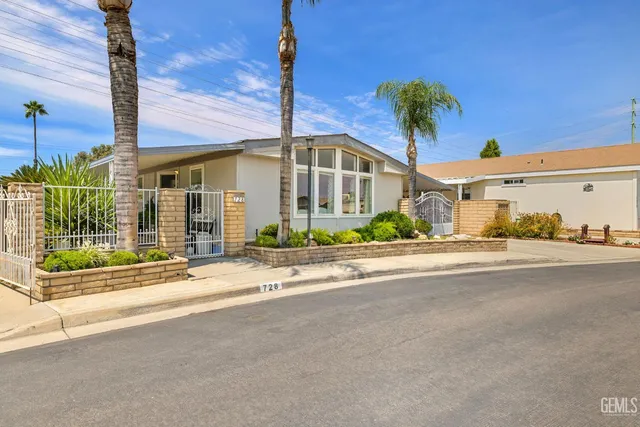 a front view of a building with palm trees