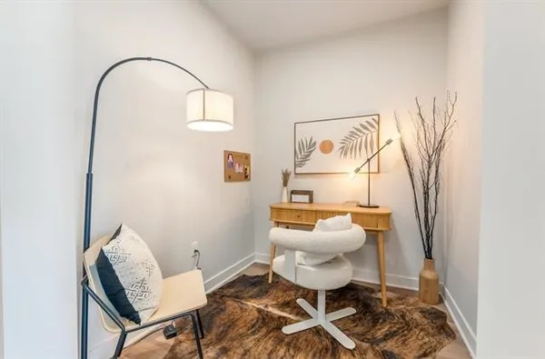 a living room with a rug and a window