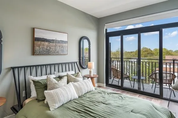 a bedroom with a bed and a large window