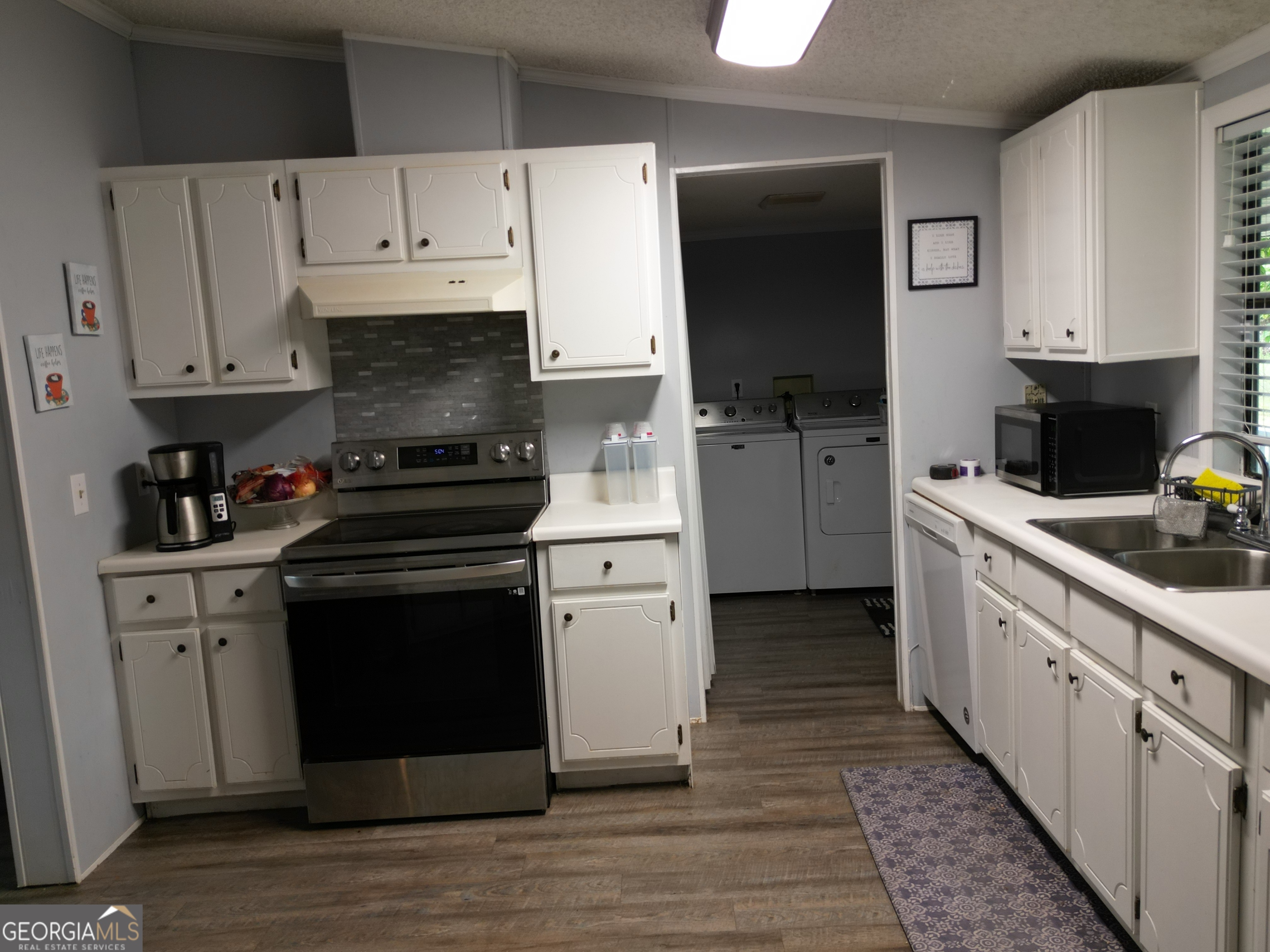 693 Old Quitman Annex Road Adel, GA 31620 - Photo 14 of 30 a kitchen with cabinets stainless steel appliances and a sink