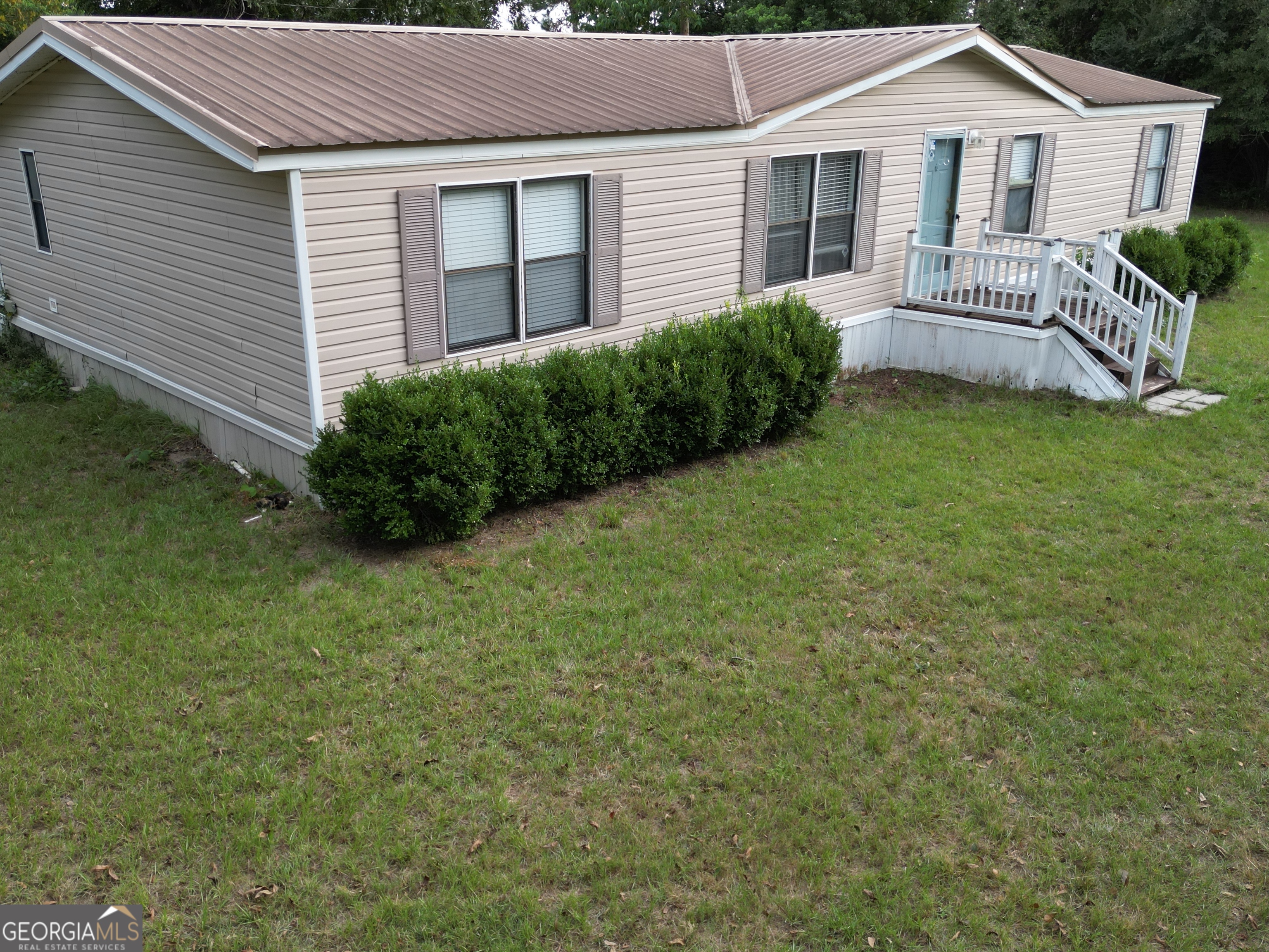 693 Old Quitman Annex Road Adel, GA 31620 - Photo 2 of 30 a view of a house with a backyard and a garden
