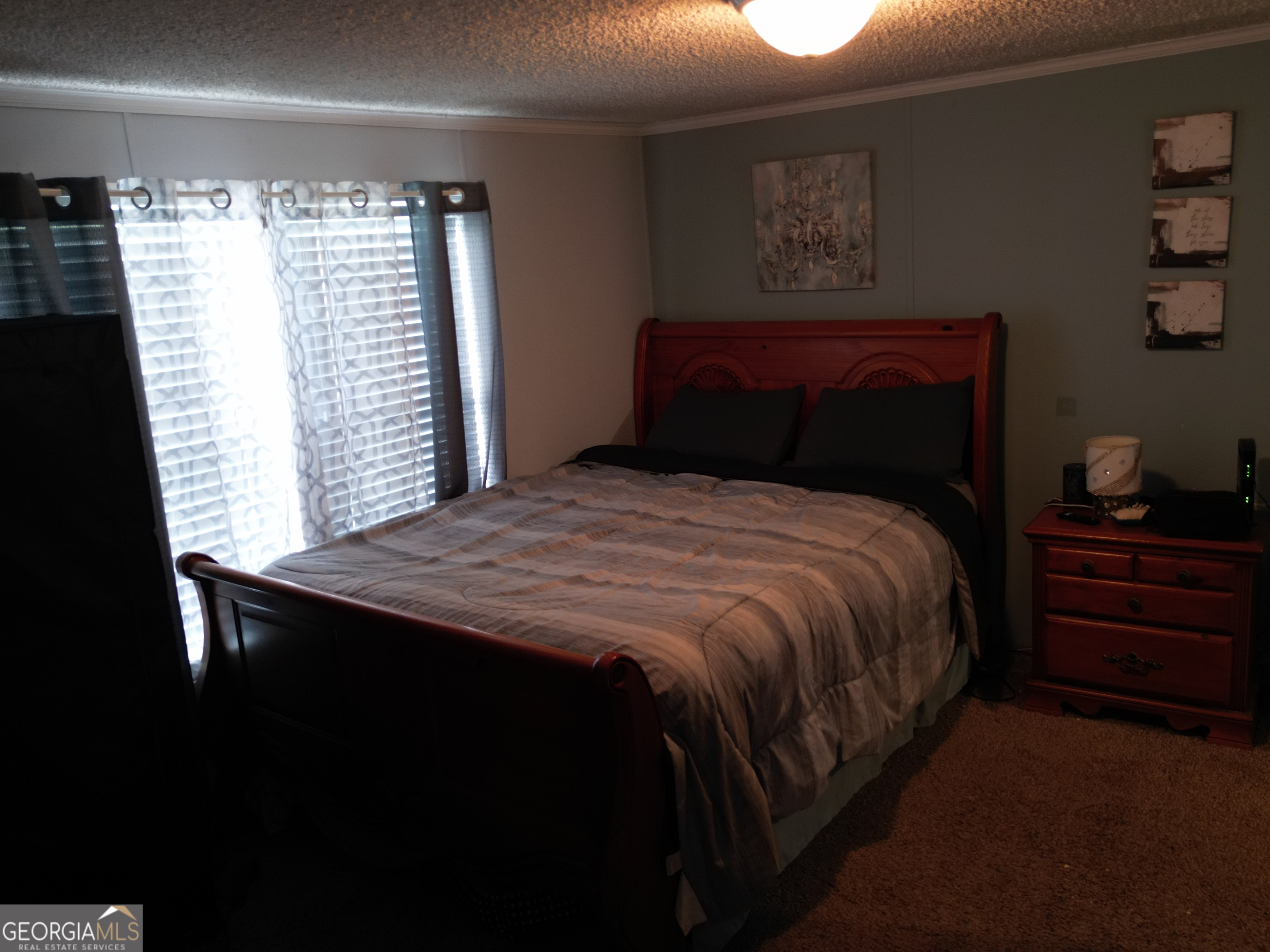 693 Old Quitman Annex Road Adel, GA 31620 - Photo 24 of 30 a bed sitting in a bedroom next to a window