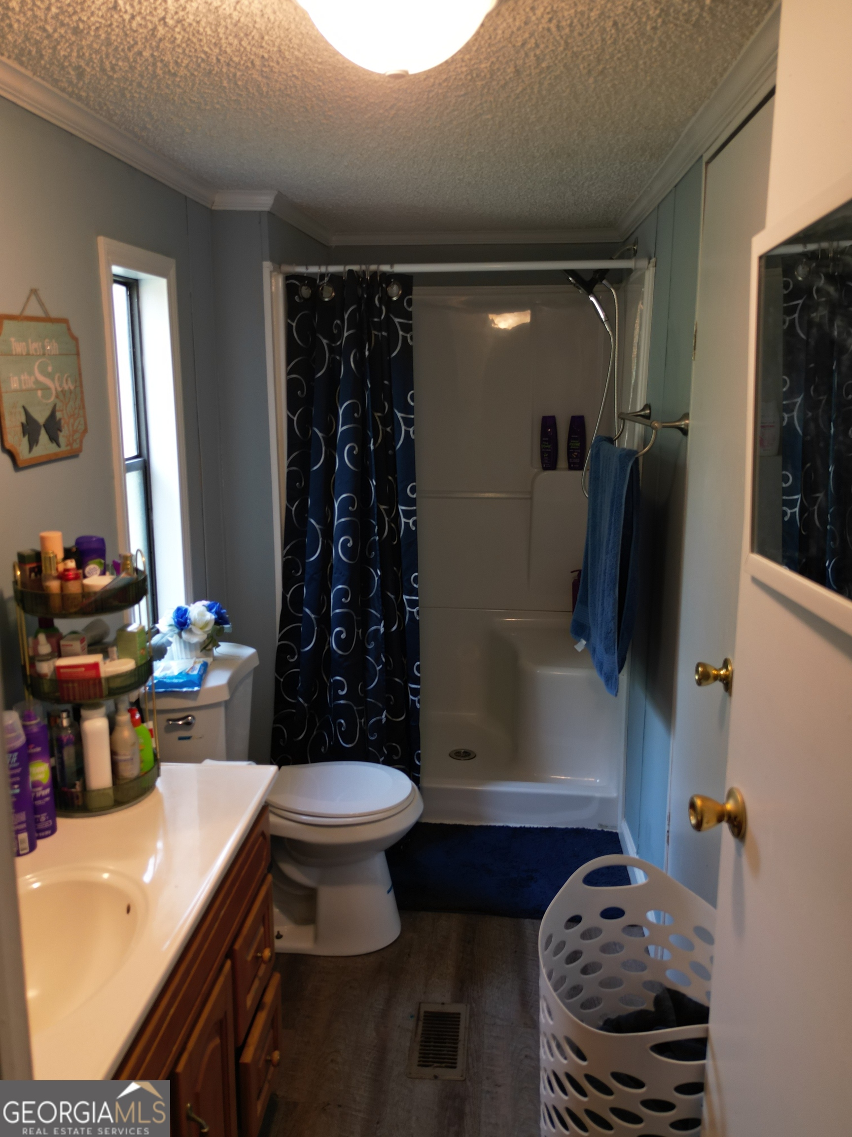 693 Old Quitman Annex Road Adel, GA 31620 - Photo 26 of 30 a bathroom with a sink toilet and shower