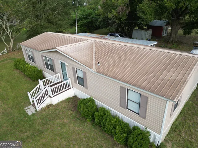 a aerial view of a house with a yard