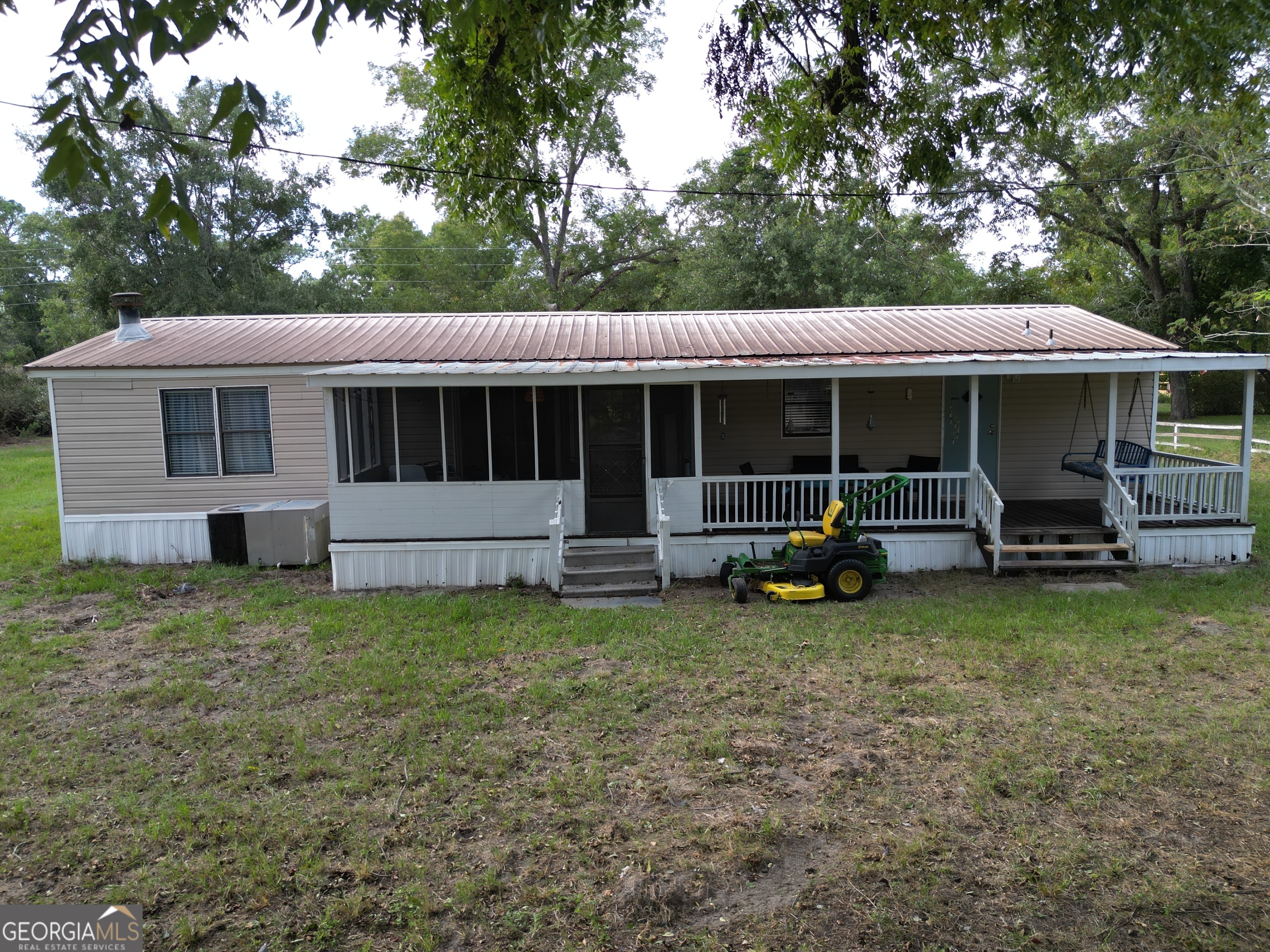 693 Old Quitman Annex Road Adel, GA 31620 - Photo 4 of 30 a view of a house with backyard sitting area and garden