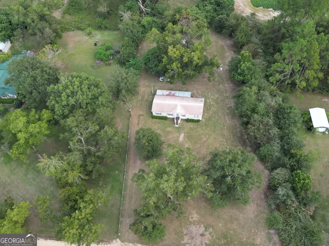 an aerial view of a house with a yard
