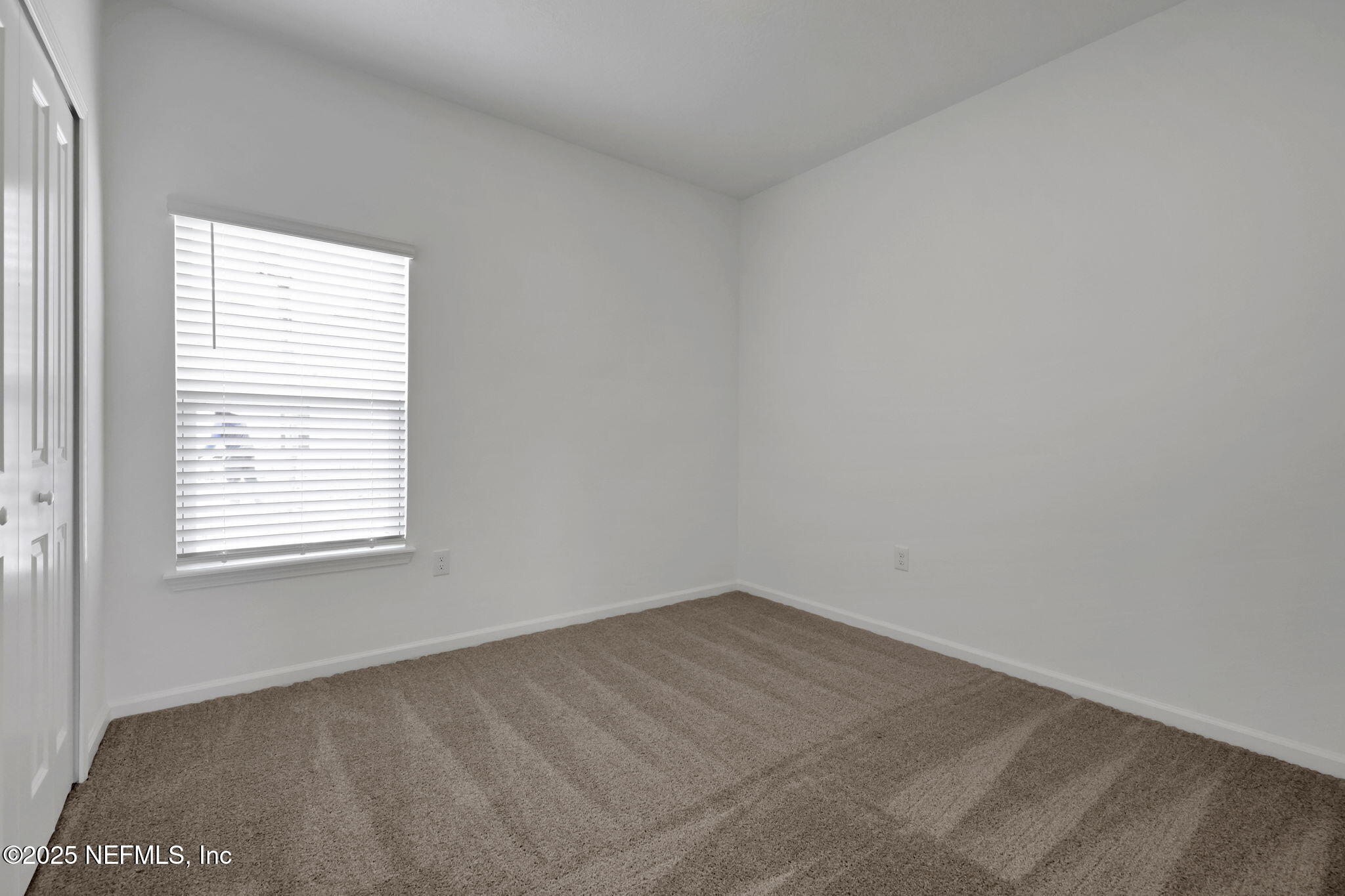191 Bluegrass Way St. Augustine, FL 32092 - Photo 23 of 62 an empty room with a window