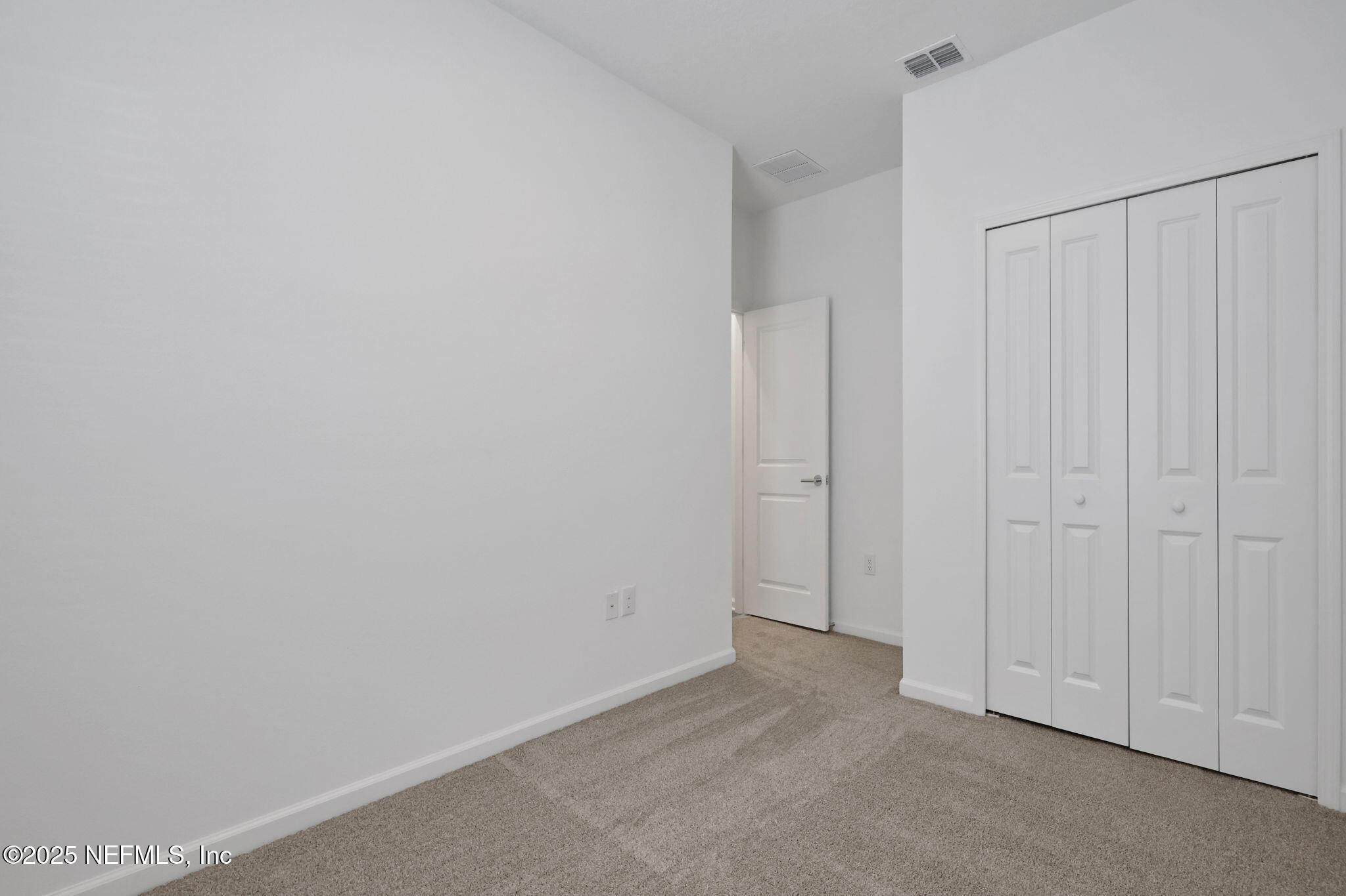 191 Bluegrass Way St. Augustine, FL 32092 - Photo 24 of 62 a view of a closet area with hardwood floor