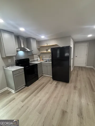 a large kitchen with stainless steel appliances granite countertop a large counter top and a stove top oven