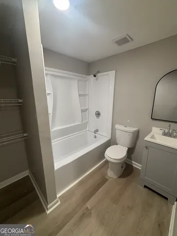 a bathroom with a toilet a sink and a bathtub