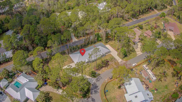 an aerial view of a house with a yard and trees