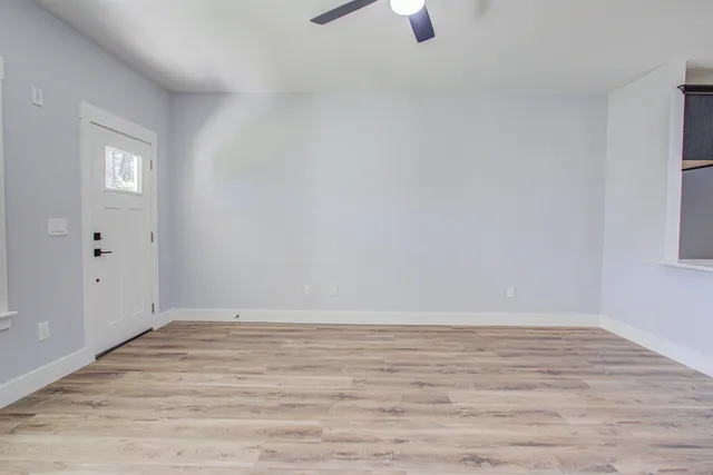 wooden floor in an empty room with a window