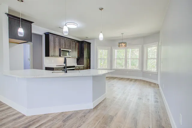 a view of a kitchen with sink hardwood and a ceiling fan