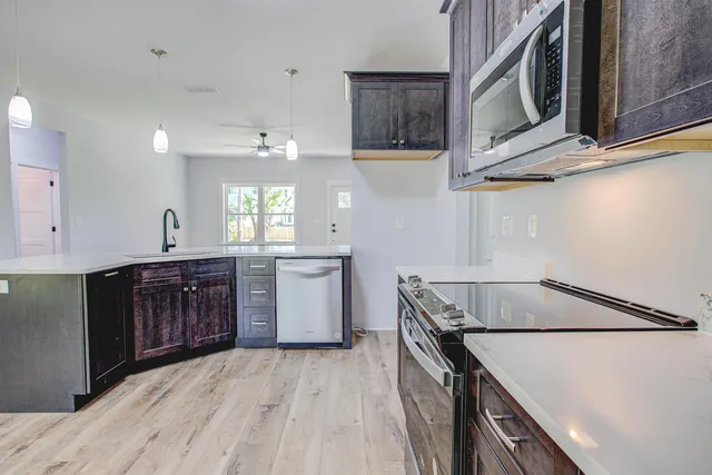 a bedroom with a large bed and a potted plant