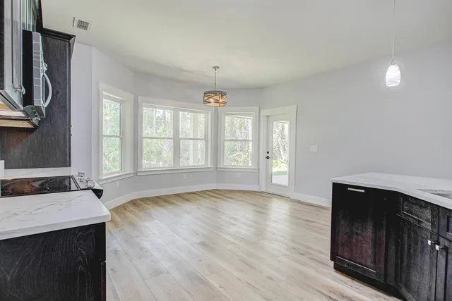 a bathroom with a granite countertop sink a mirror and shower