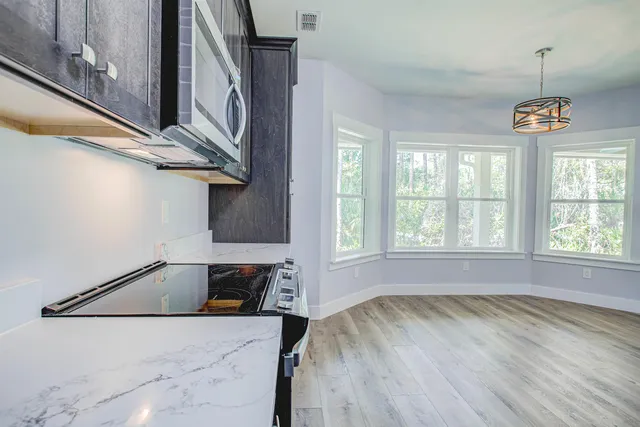 a spacious bathroom with double sink and a mirror