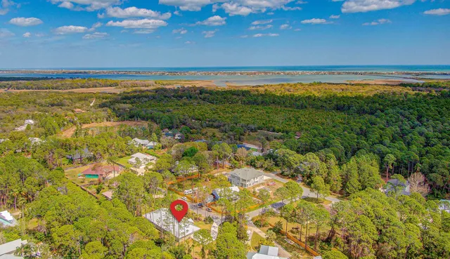 an aerial view of a house with a yard
