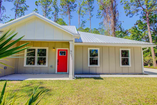 an empty room with wooden floor windows and fan