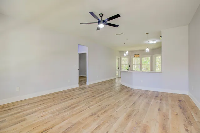 a view of an empty room and wooden floor