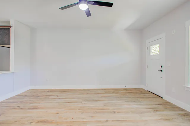 an empty room with windows and outdoor view