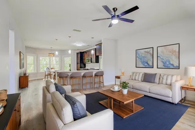 a view of an empty room with a window and a ceiling fan