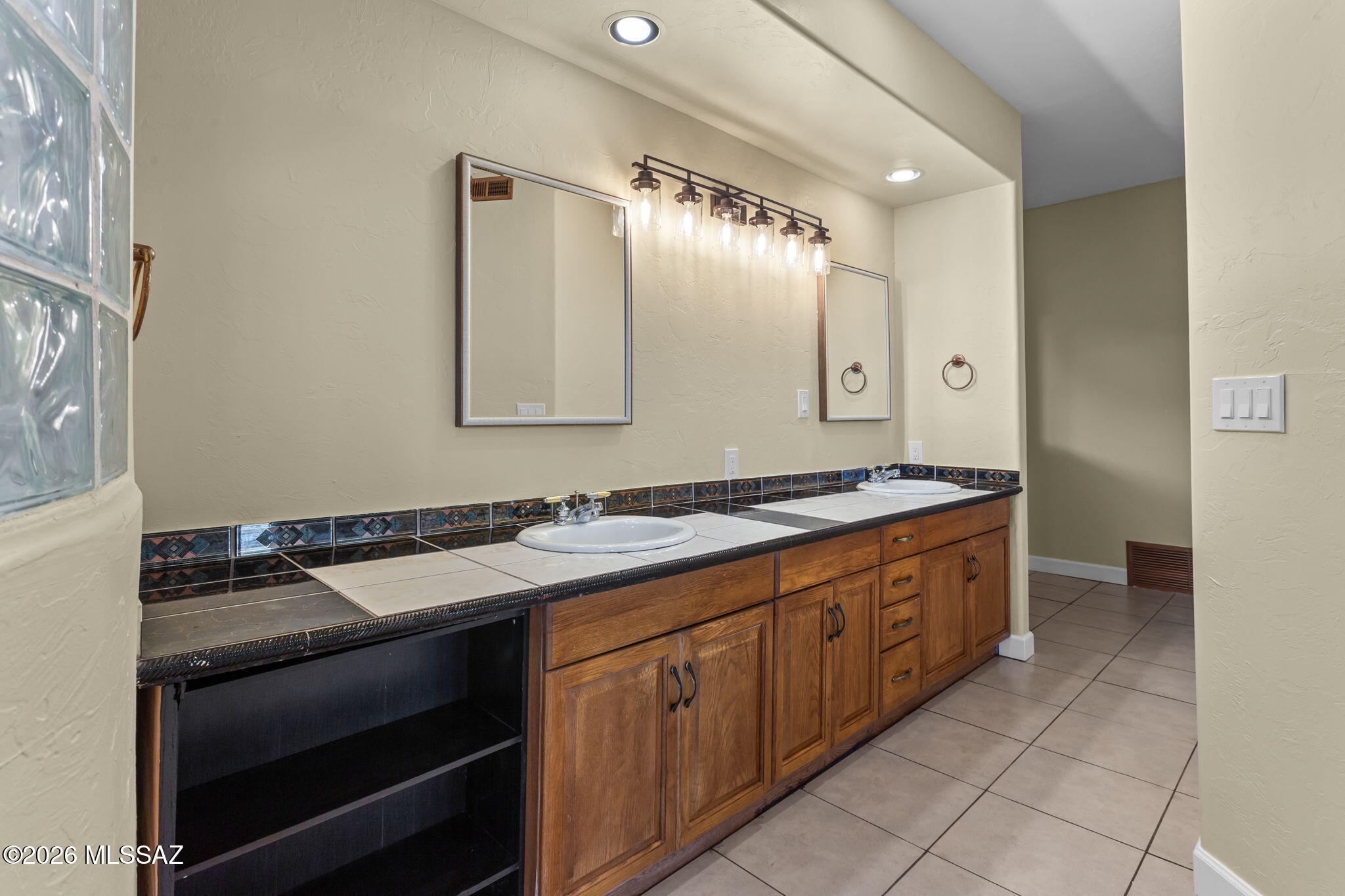 4210 West Mossman Road Tucson, AZ 85746 - Photo 20 of 51 a bathroom with a granite countertop sink and a mirror