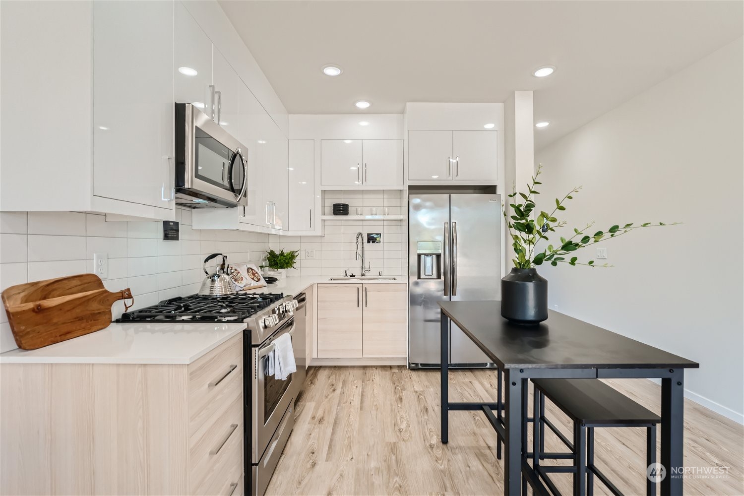 1916 South Grand Street Seattle, WA 98144 - Photo 9 of 26 a kitchen with stainless steel appliances kitchen island granite countertop a stove a sink a refrigerator and cabinets