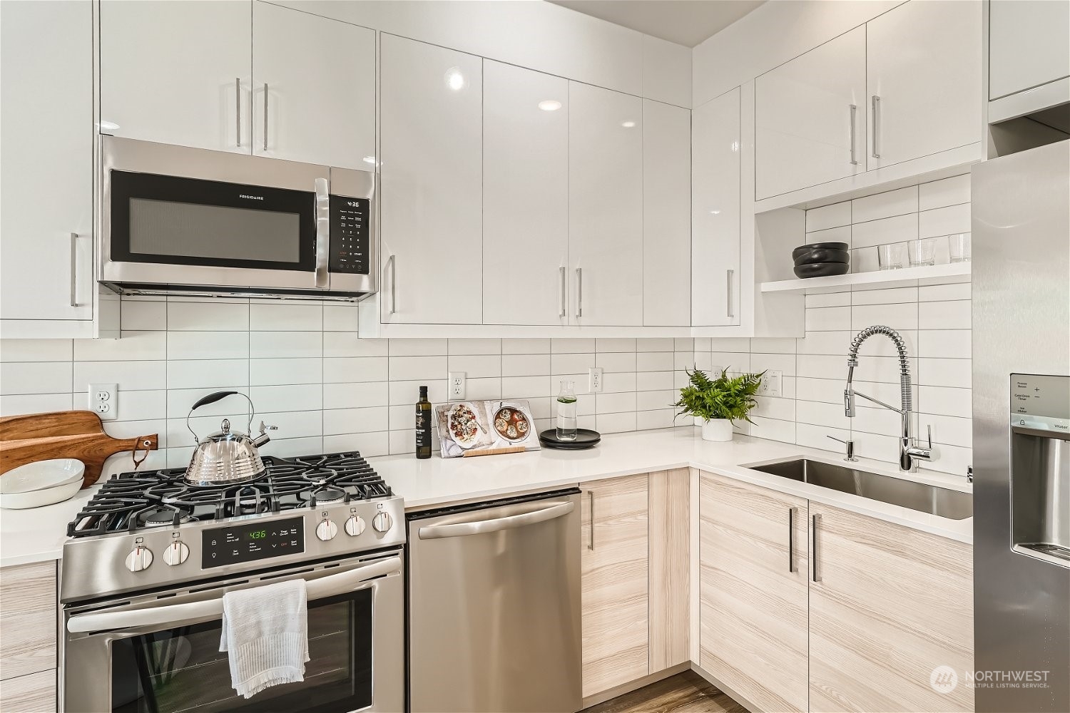 1916 South Grand Street Seattle, WA 98144 - Photo 10 of 26 a kitchen with stainless steel appliances a stove microwave and cabinets