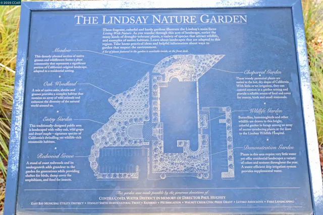 a sign broad in front of flowers