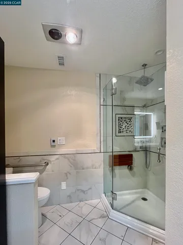 a bathroom with a shower and toilet