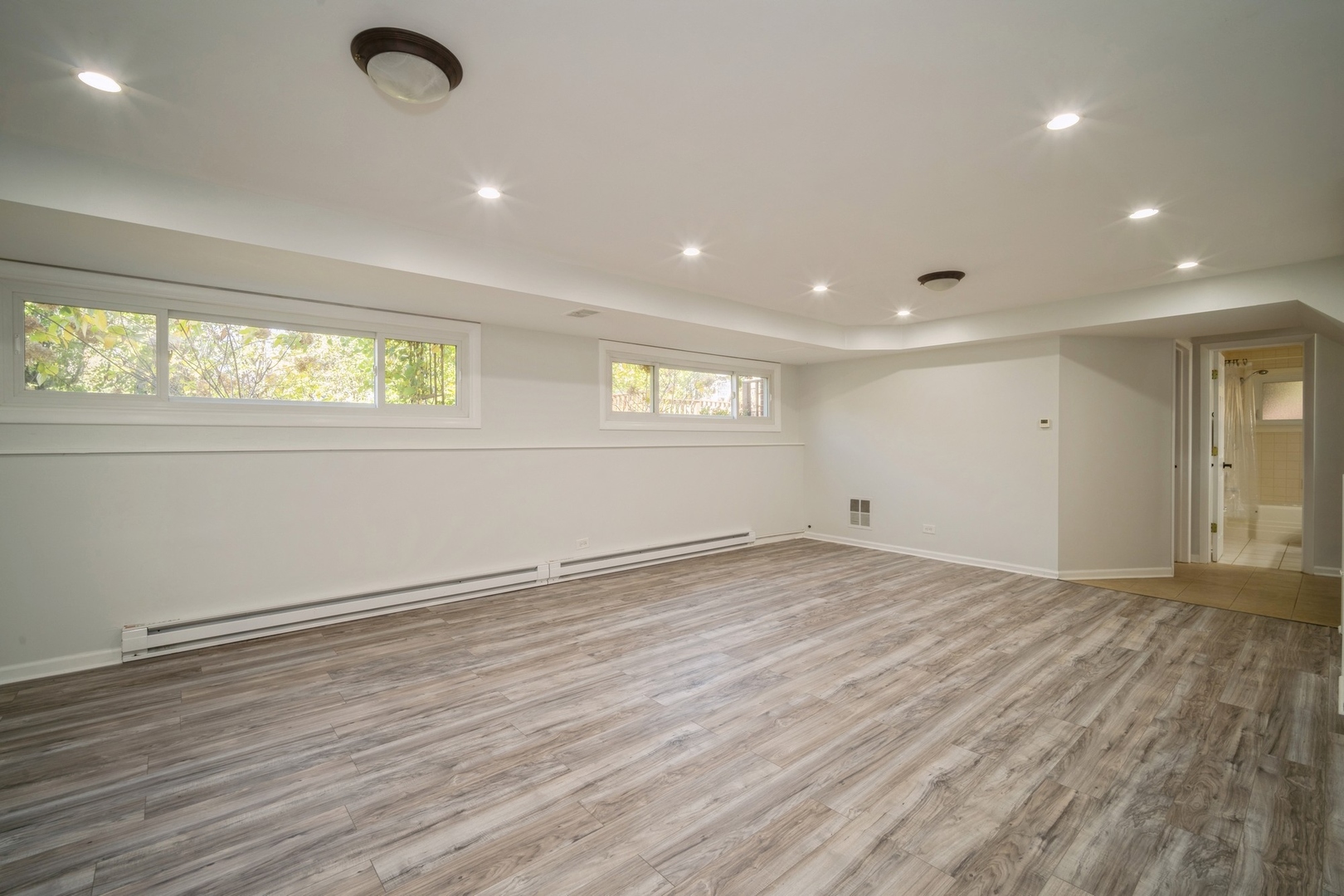 1450 Wescott Road Northbrook, IL 60062 - Photo 14 of 22 an empty room with wooden floor and windows