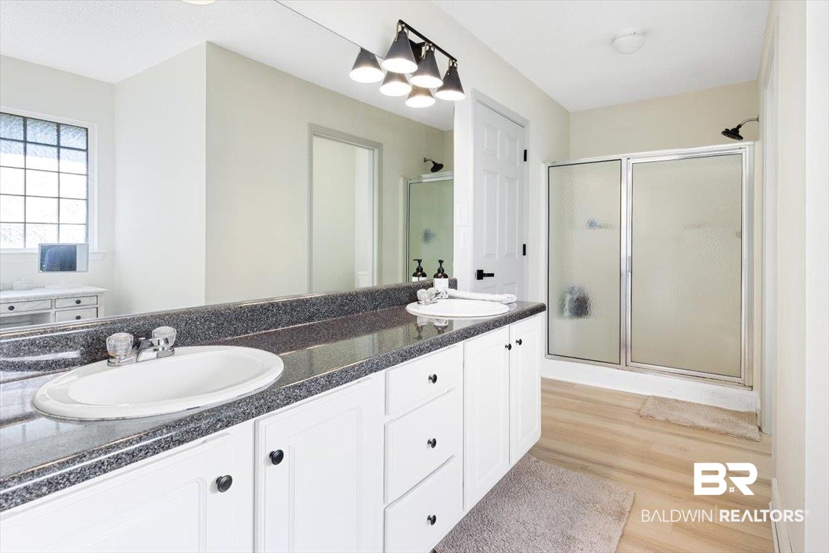 27809 Rileywood Drive Daphne, AL 36526 - Photo 20 of 38 Bathroom featuring hardwood / wood-style flooring, an enclosed shower, and vanity