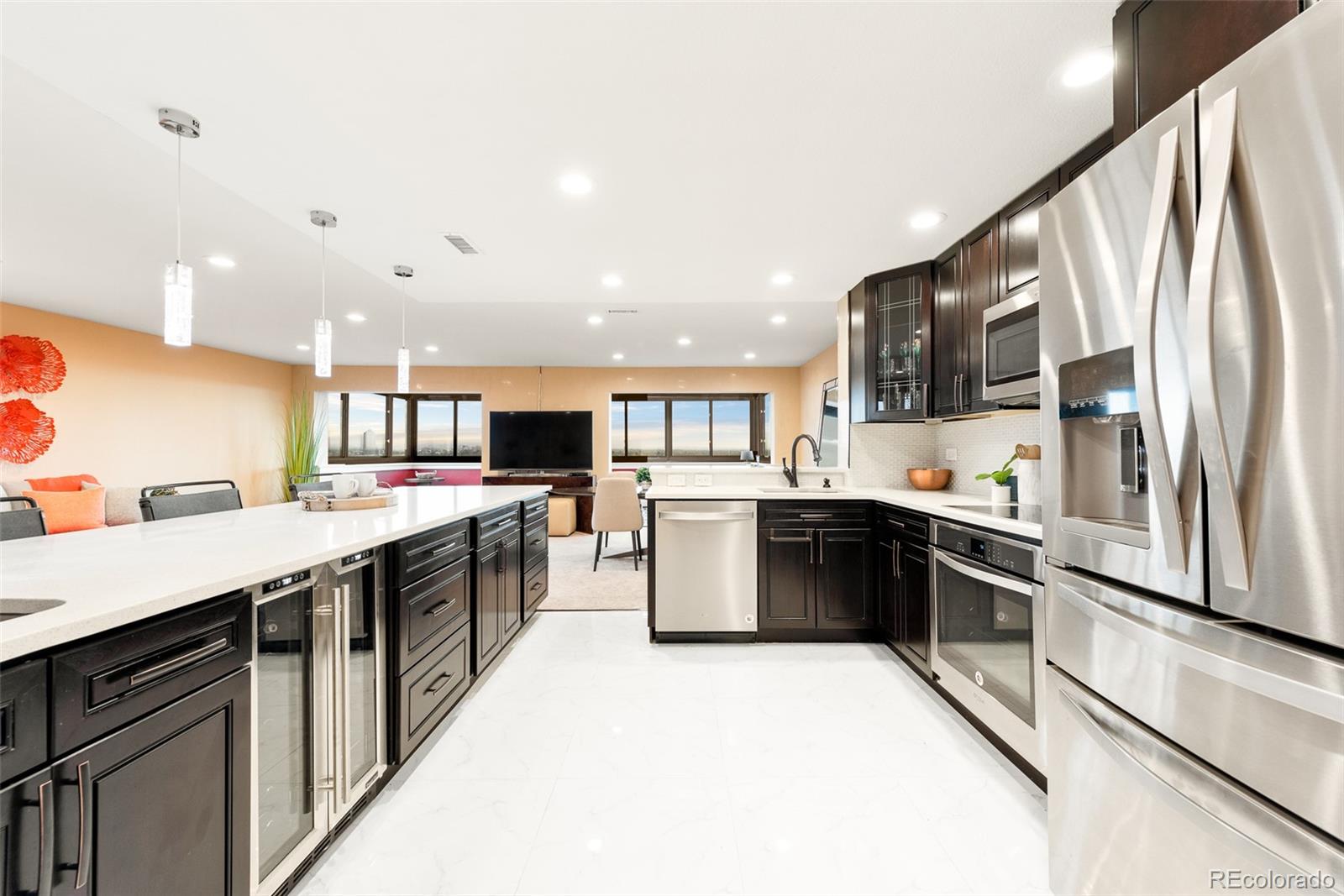a large kitchen with stainless steel appliances kitchen island granite countertop a large kitchen island and a sink