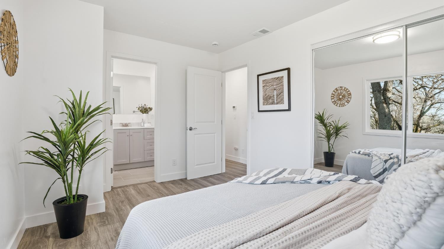 6741 Big Sandy Lane Placerville, CA 95667 - Photo 11 of 25 a bedroom with a large bed and a potted plant