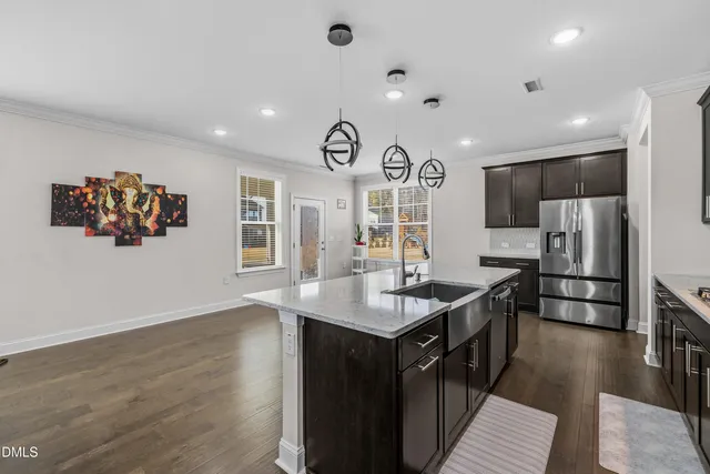 a kitchen with stainless steel appliances granite countertop a sink stove and refrigerator