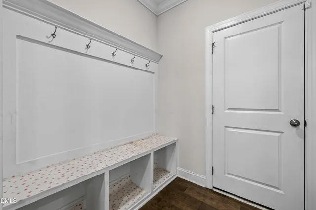 a view of cabinets and utility room with wooden floor