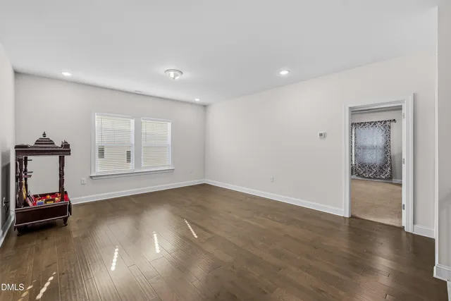 a view of empty room with closet and wooden floor