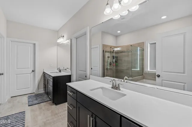 a bathroom with a sink double vanity and a mirror